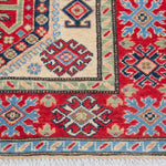 Border and edge detail of ivory & red Kazak-inspired wool rug 29652.