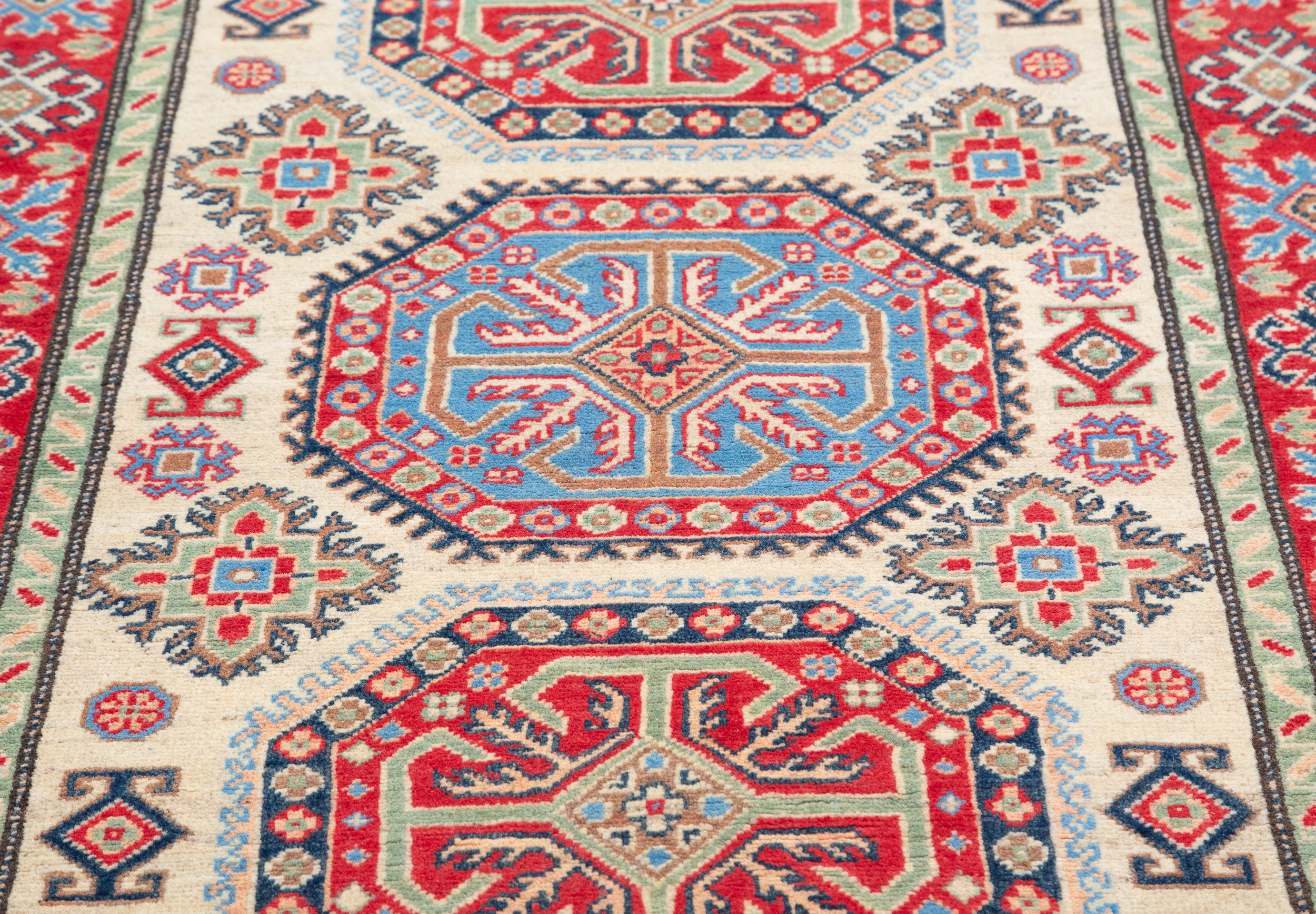 Pattern detail of ivory & red Kazak-inspired wool rug 29652.