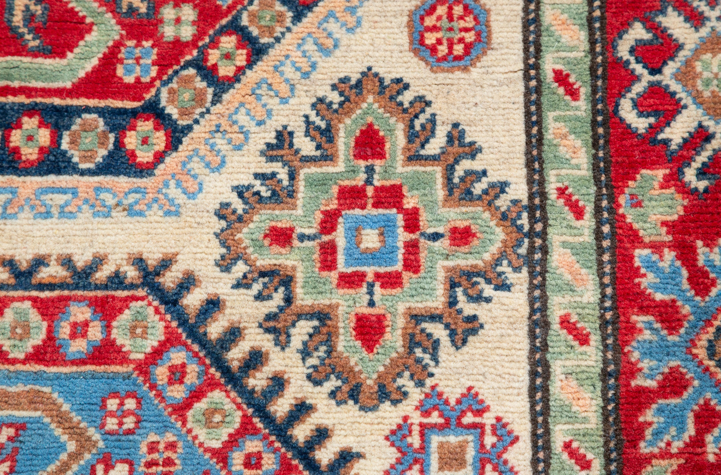 Pattern detail of ivory & red Kazak-inspired wool rug 29652.