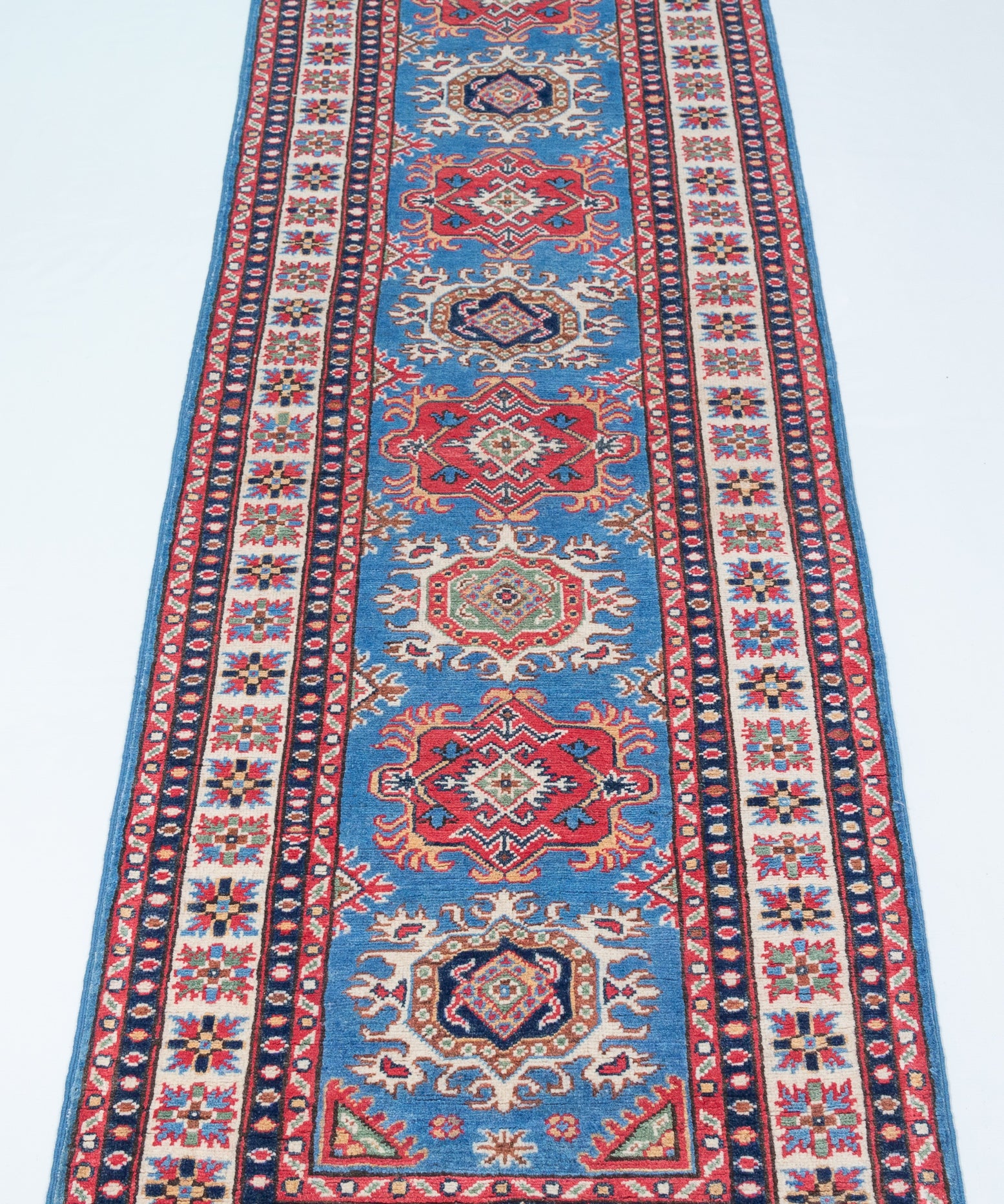 Full view from a low angle of blue & red Kazak-inspired wool runner 29653.