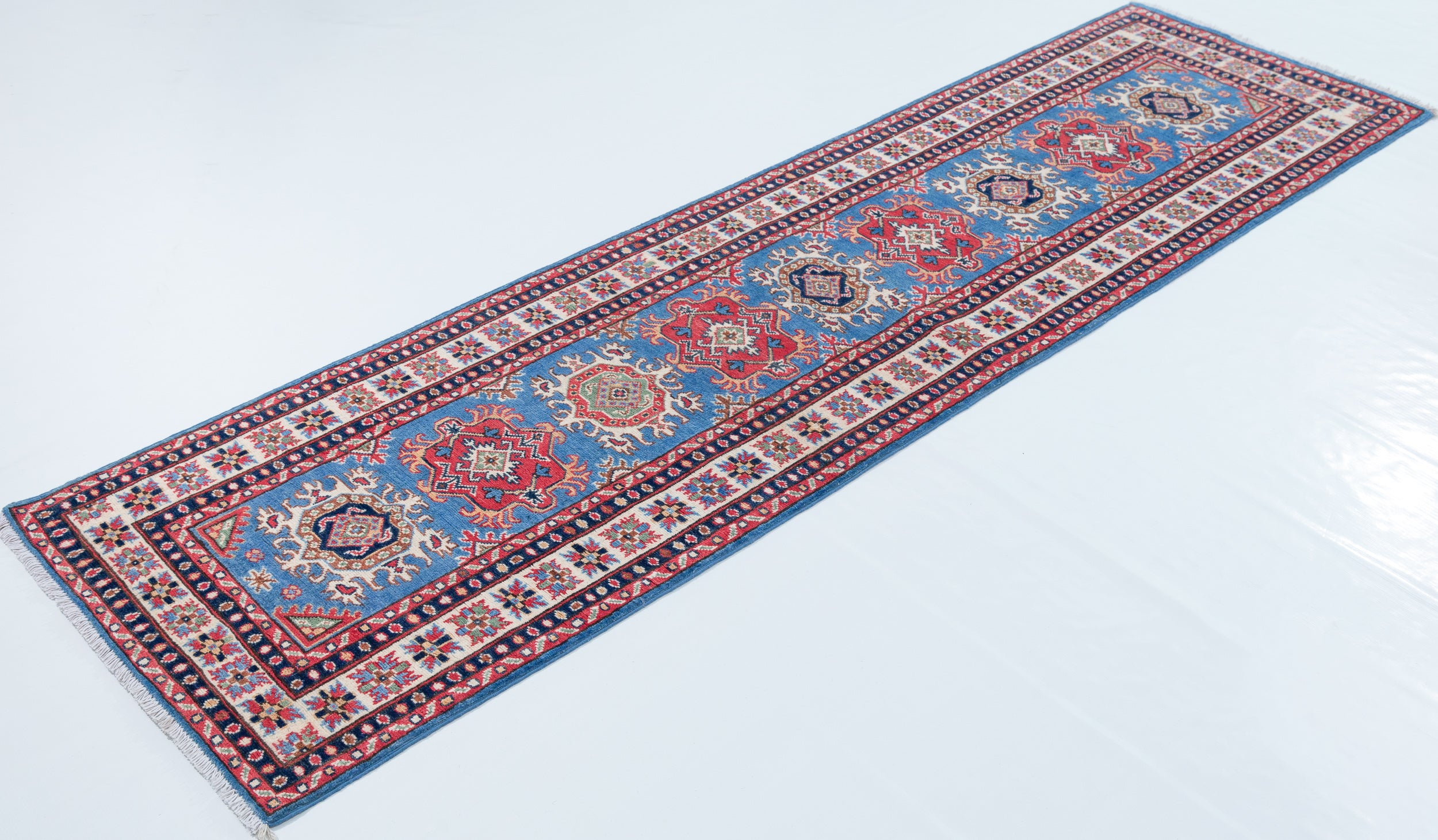 Full view at an angle of blue & red Kazak-inspired wool runner 29653.