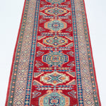 Full view from a low angle of red & blue Kazak-inspired wool runner 29654.