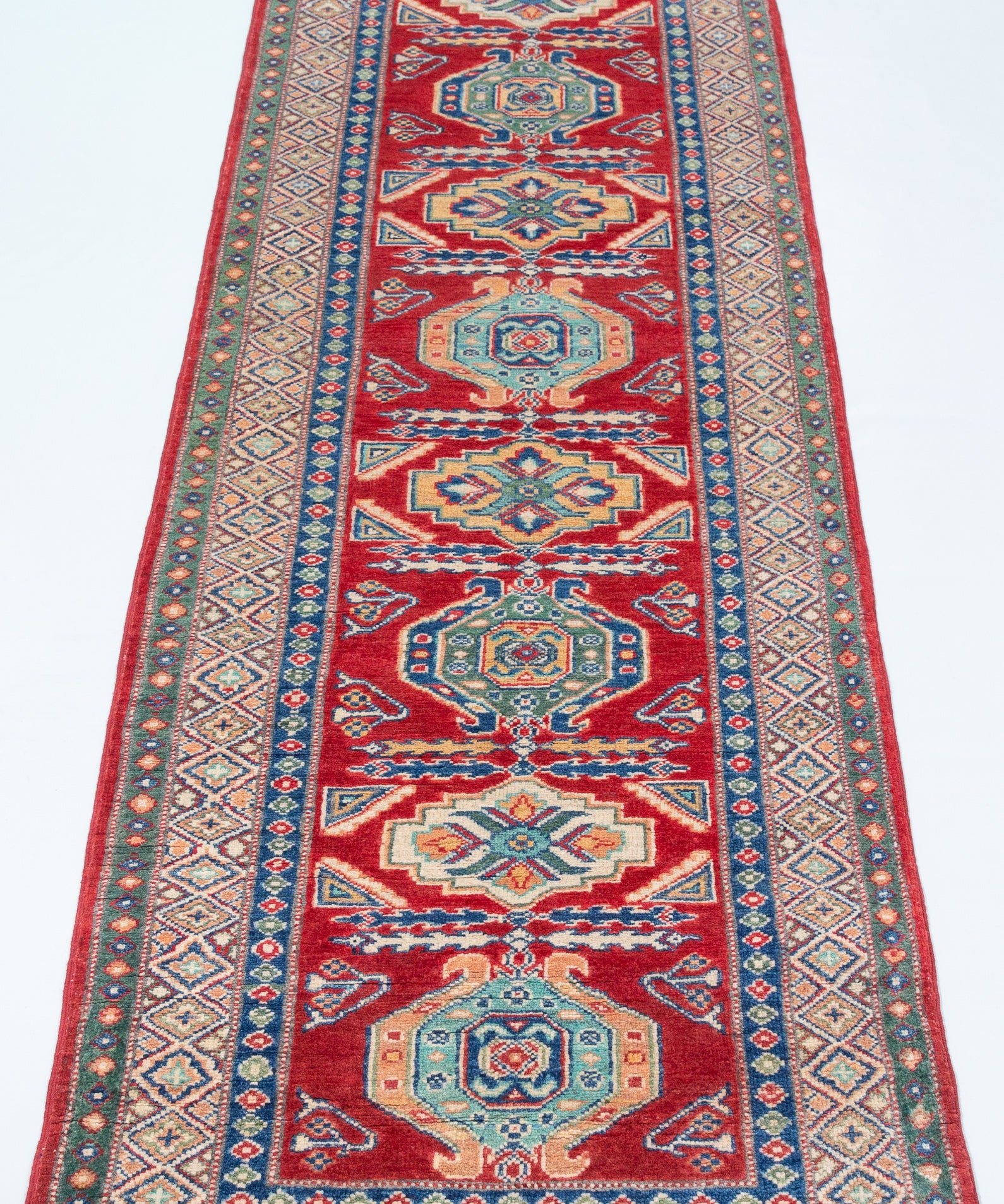 Full view from a low angle of red & blue Kazak-inspired wool runner 29654.