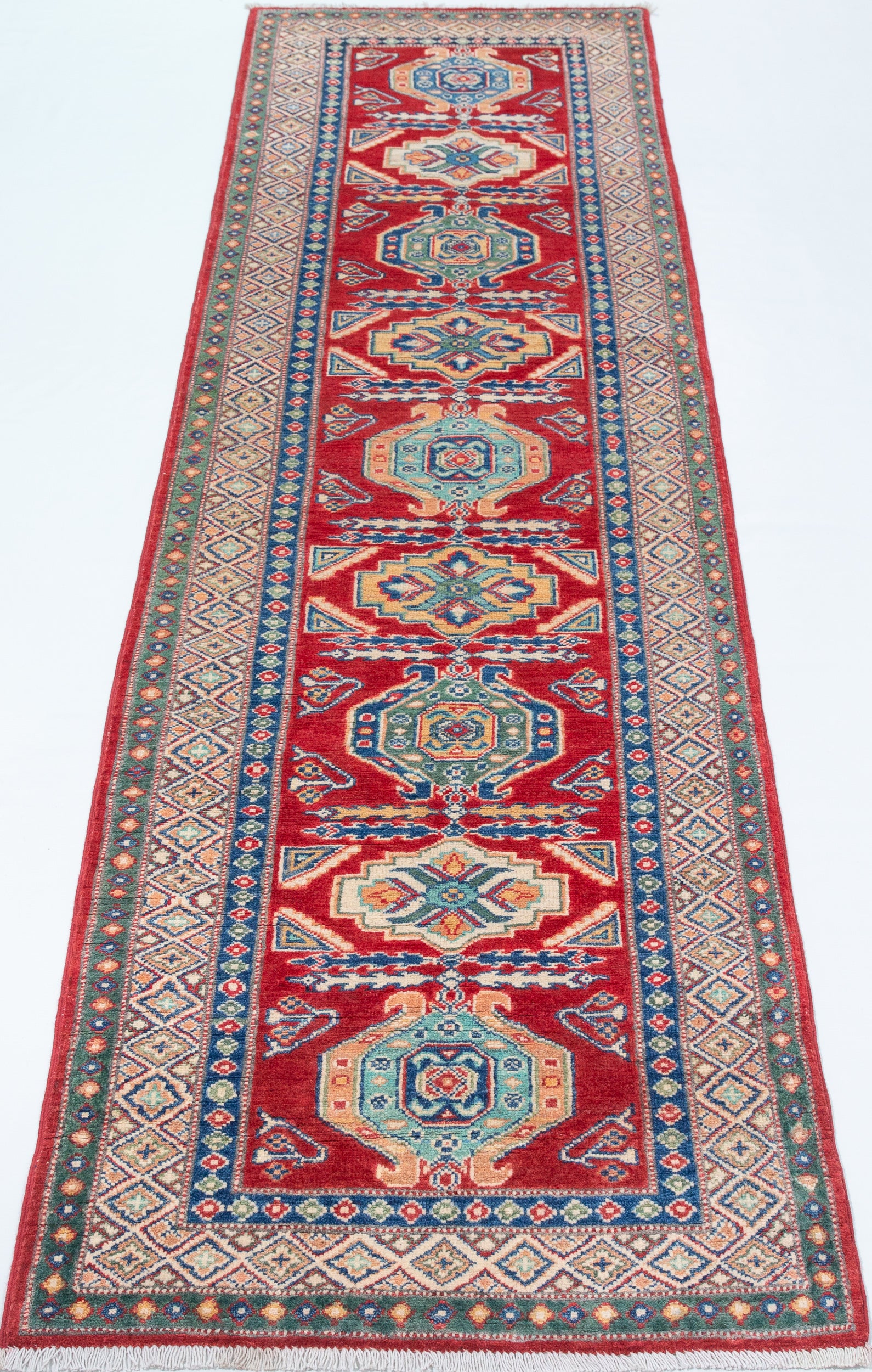 Full view from a low angle of red & blue Kazak-inspired wool runner 29654.