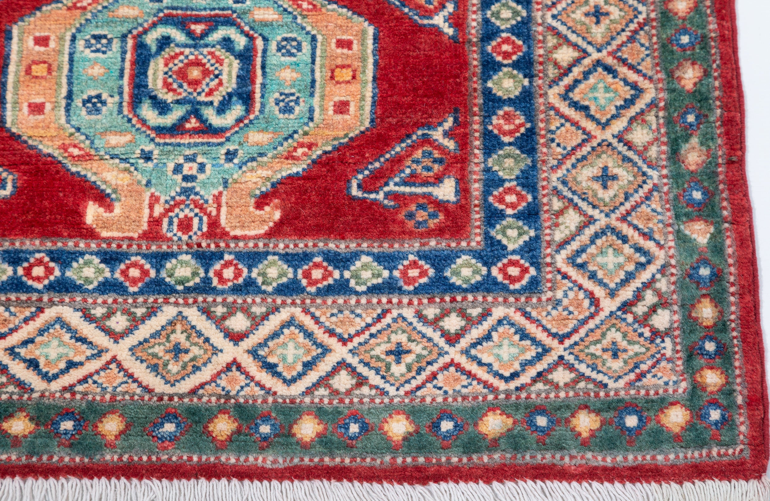Border and edge detail of red & blue Kazak-inspired wool runner 29654.