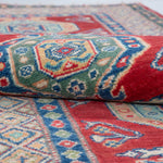 Folded edge and wool pile of red & blue Kazak-inspired wool runner 29654.