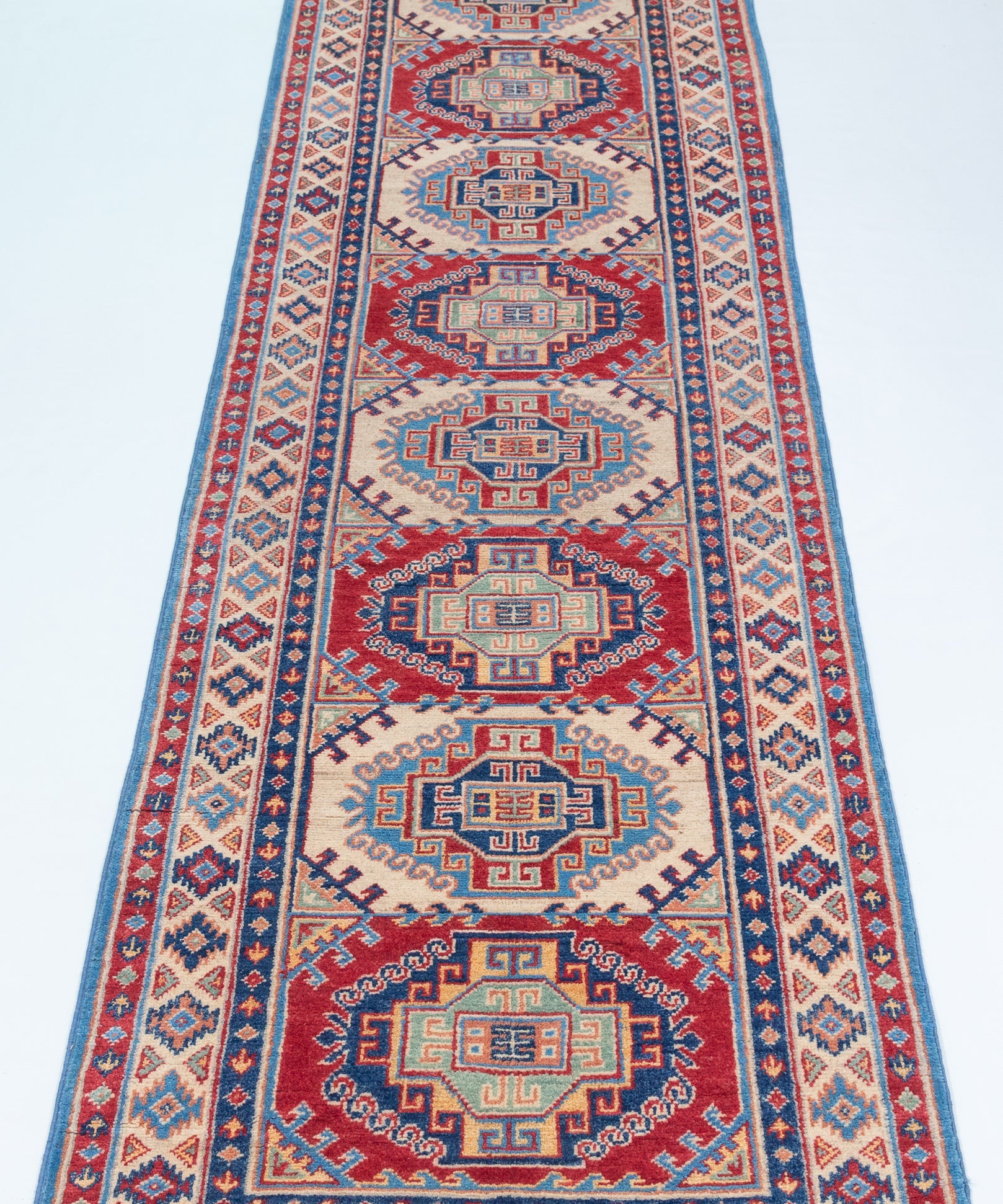 Full view from a low angle of blue & red Kazak-inspired wool runner 29656.