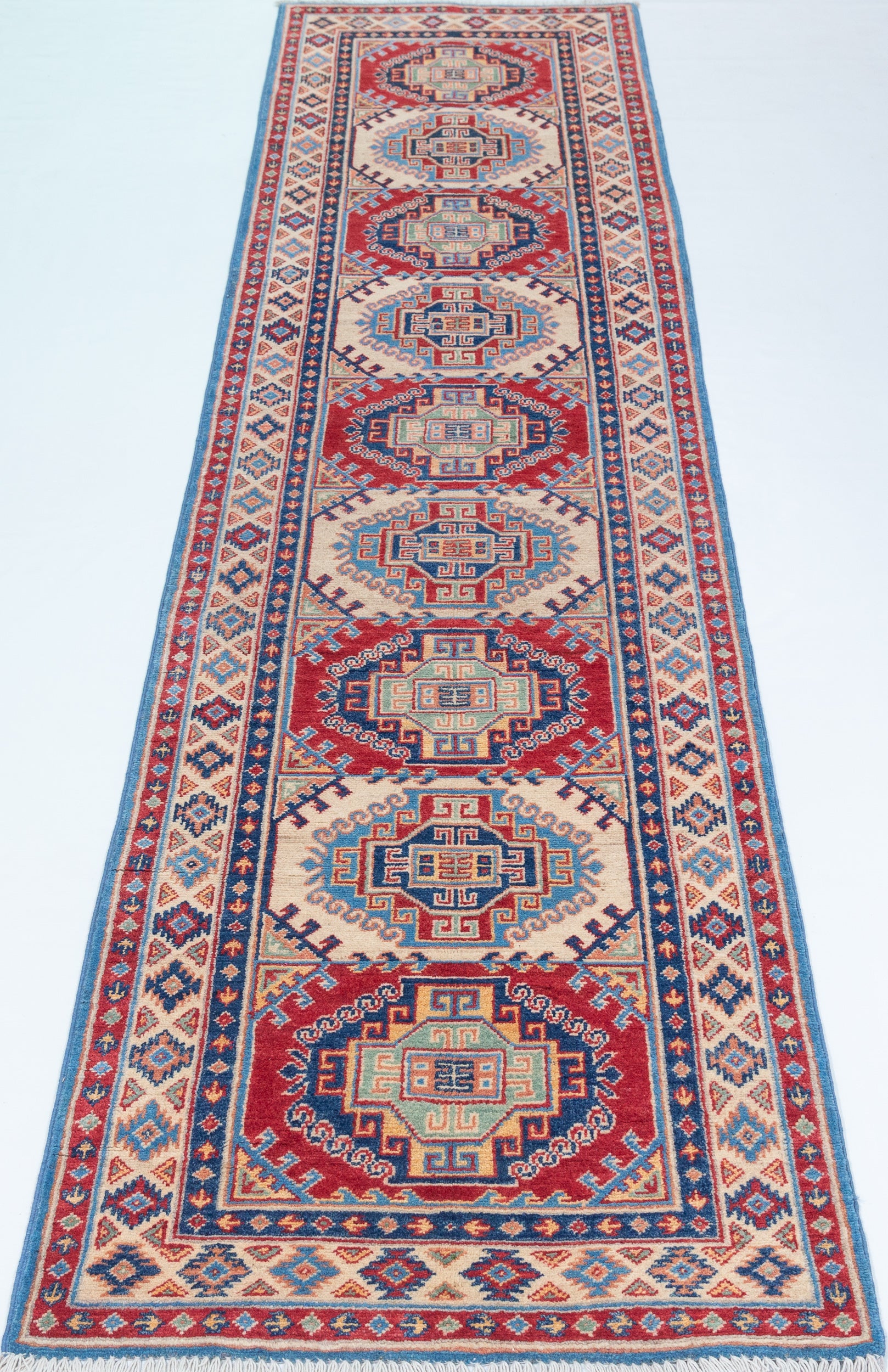 Full view from a low angle of blue & red Kazak-inspired wool runner 29656.