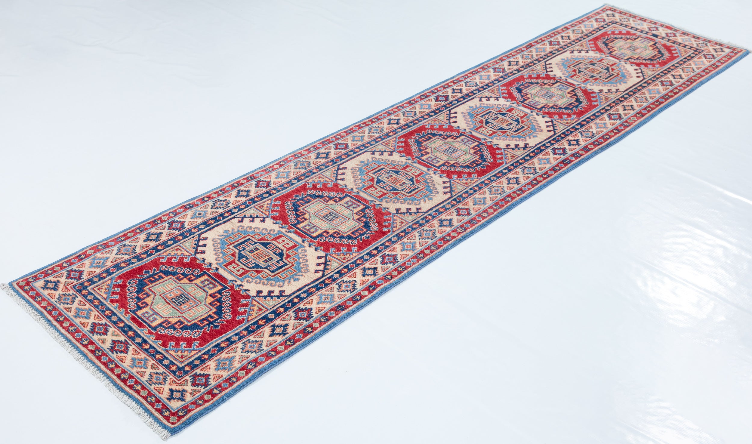 Full view at an angle of blue & red Kazak-inspired wool runner 29656.