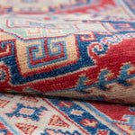 Folded edge and wool pile of blue & red Kazak-inspired wool runner 29656.