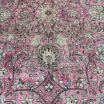 Persian Tabriz rug pattern close-up: dusty rose medallions with light green and cream details
