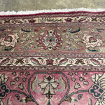 Persian Tabriz rug close-up of floral border in dusty rose, cream, and dark accents