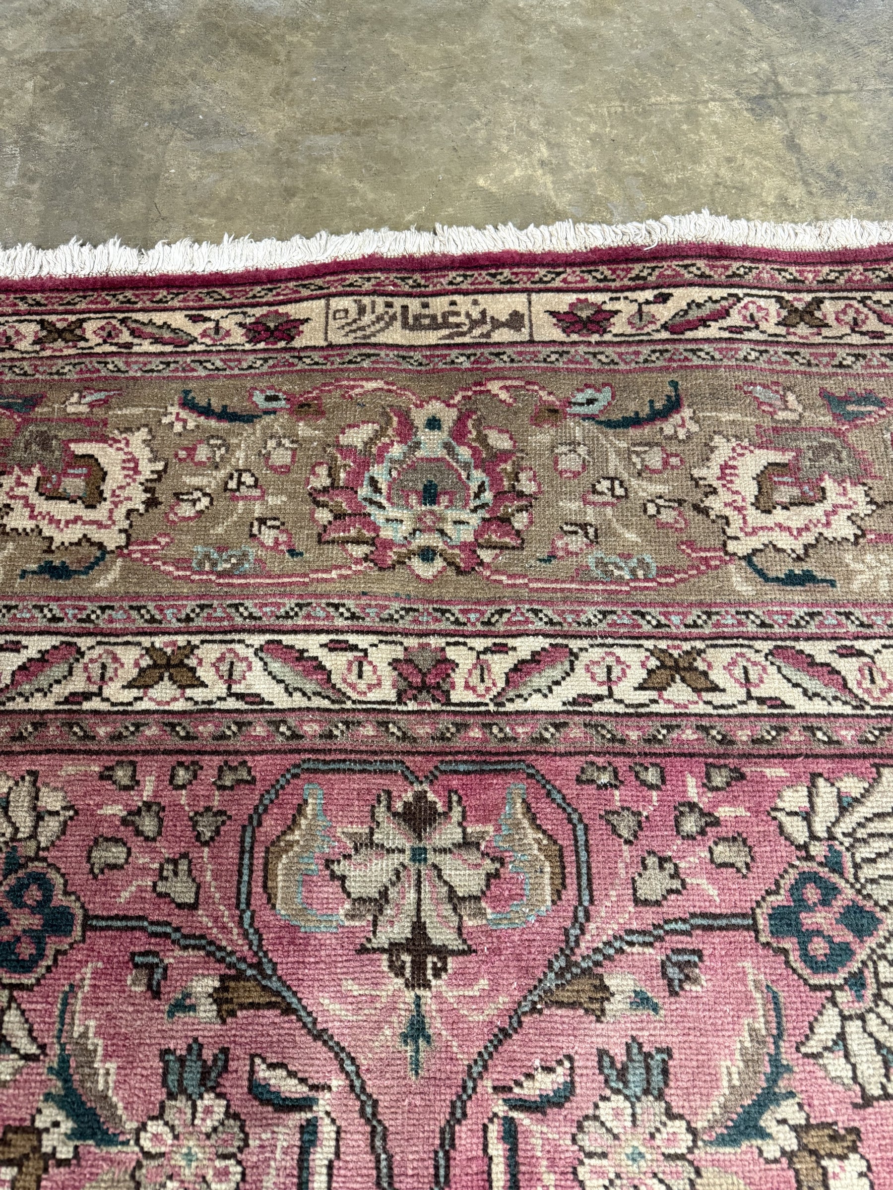 Persian Tabriz rug close-up of floral border in dusty rose, cream, and dark accents