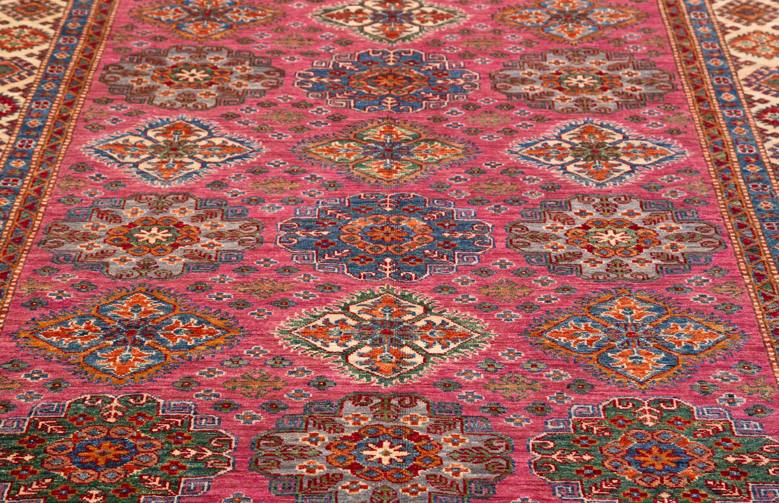 Afghan Super Kazak Rug in rose, navy and gold — pattern, texture or angled view