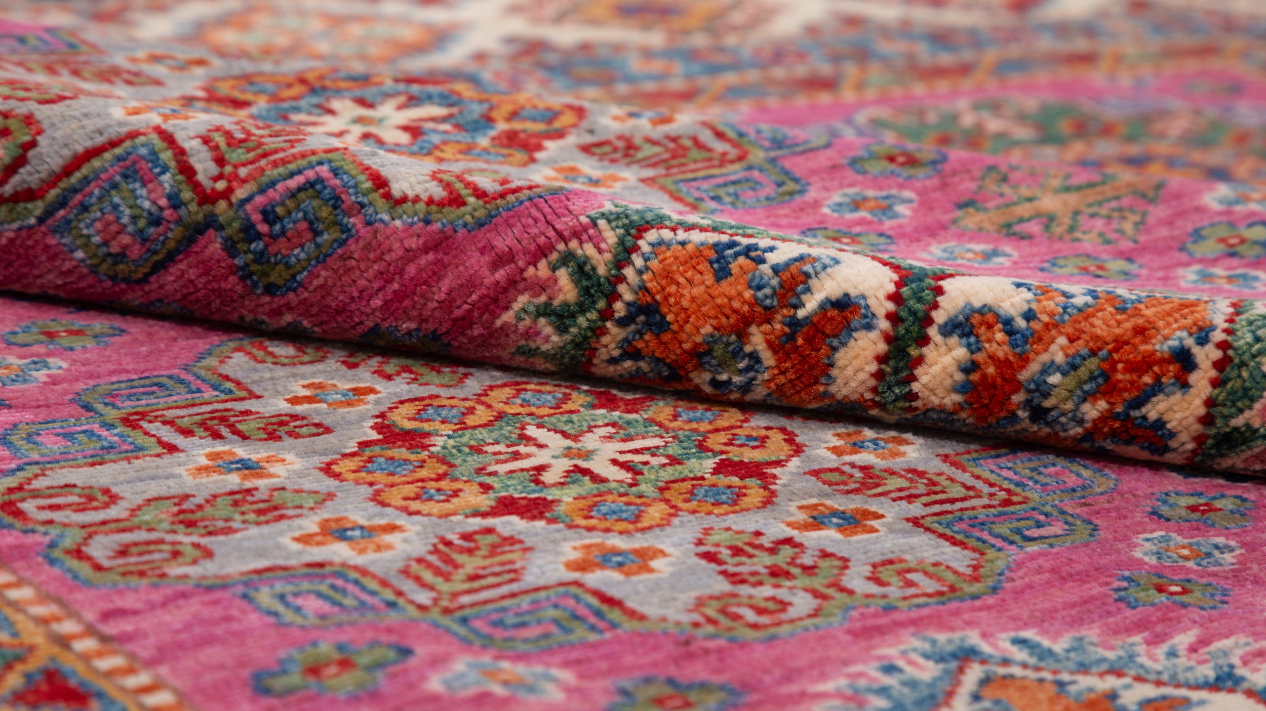 Afghan Super Kazak Rug in rose, navy and gold — pattern, texture or angled view