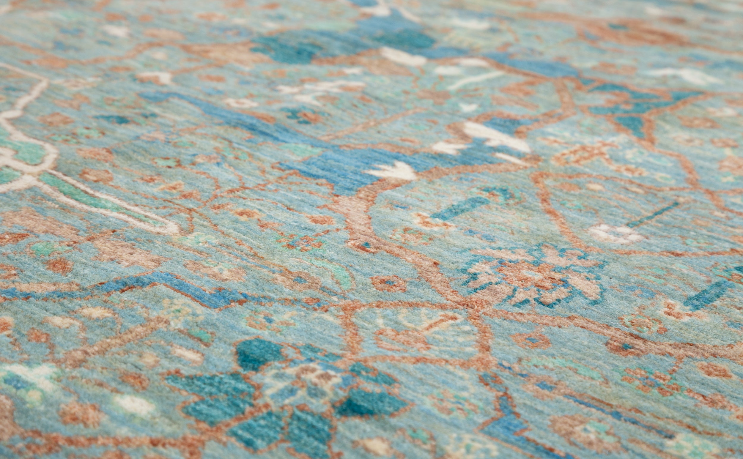 Chobbi Rug in pale turquoise and sand — pattern, texture or angled view