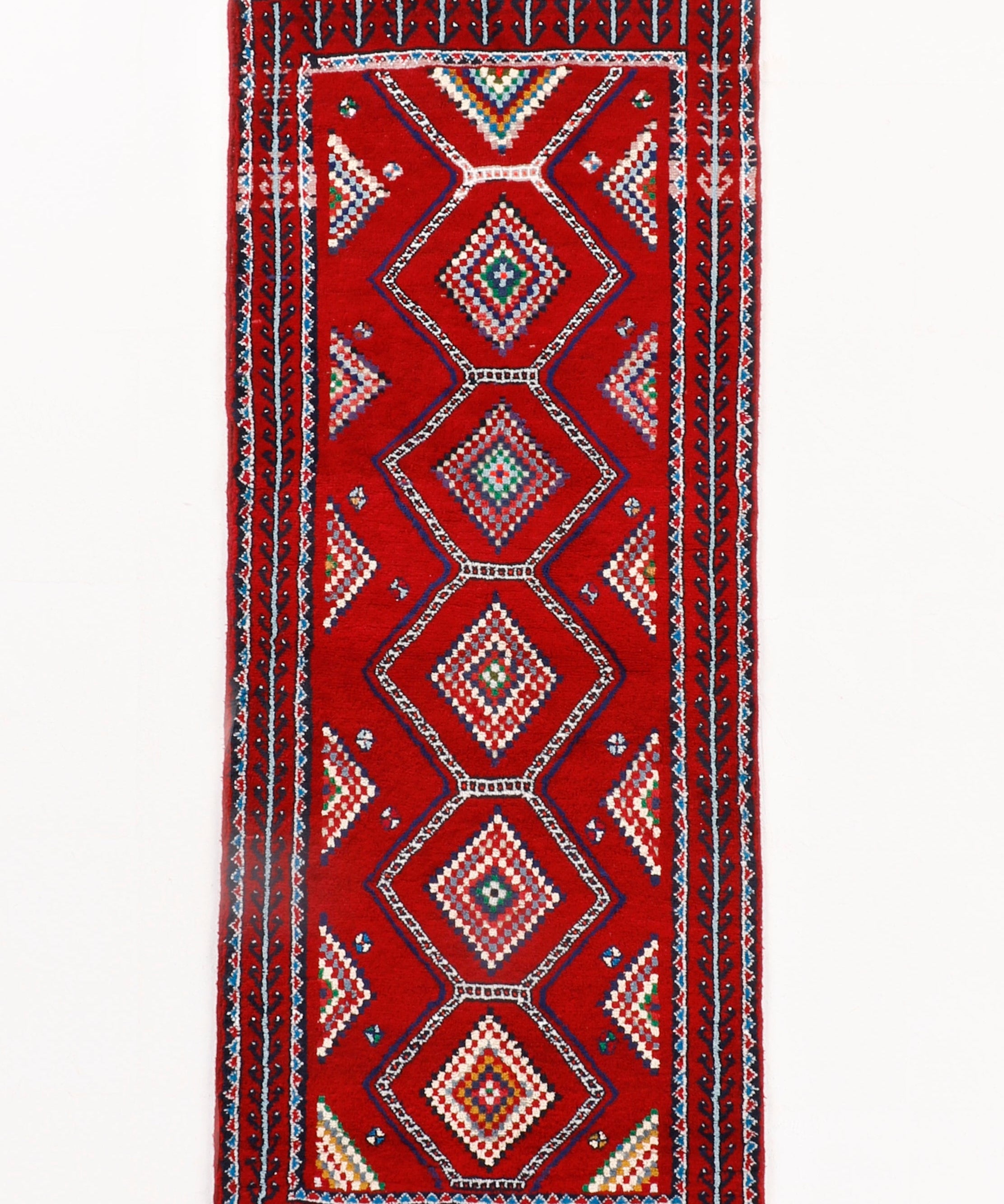 Persian Baluch runner rug, red field with navy diamond medallions and white fringe