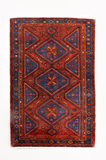 Persian Hamadan rug with red center medallion, navy corners, and patterned border