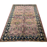 Vintage Sarouk Rug, full rug in perspective showing the patterned field and borders, hand-knotted wool pile. SKU EE 1.0236.
