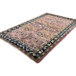 Vintage Sarouk Rug, angled view showing the full field and borders, hand-knotted wool pile. SKU EE 1.0236.