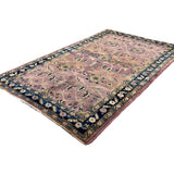 Vintage Sarouk Rug, angled view showing the full field and borders, hand-knotted wool pile. SKU EE 1.0236.