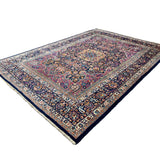 Vintage Mashhad Rug, angled view showing the full field and borders, hand-knotted wool pile. SKU EE 1.0651.