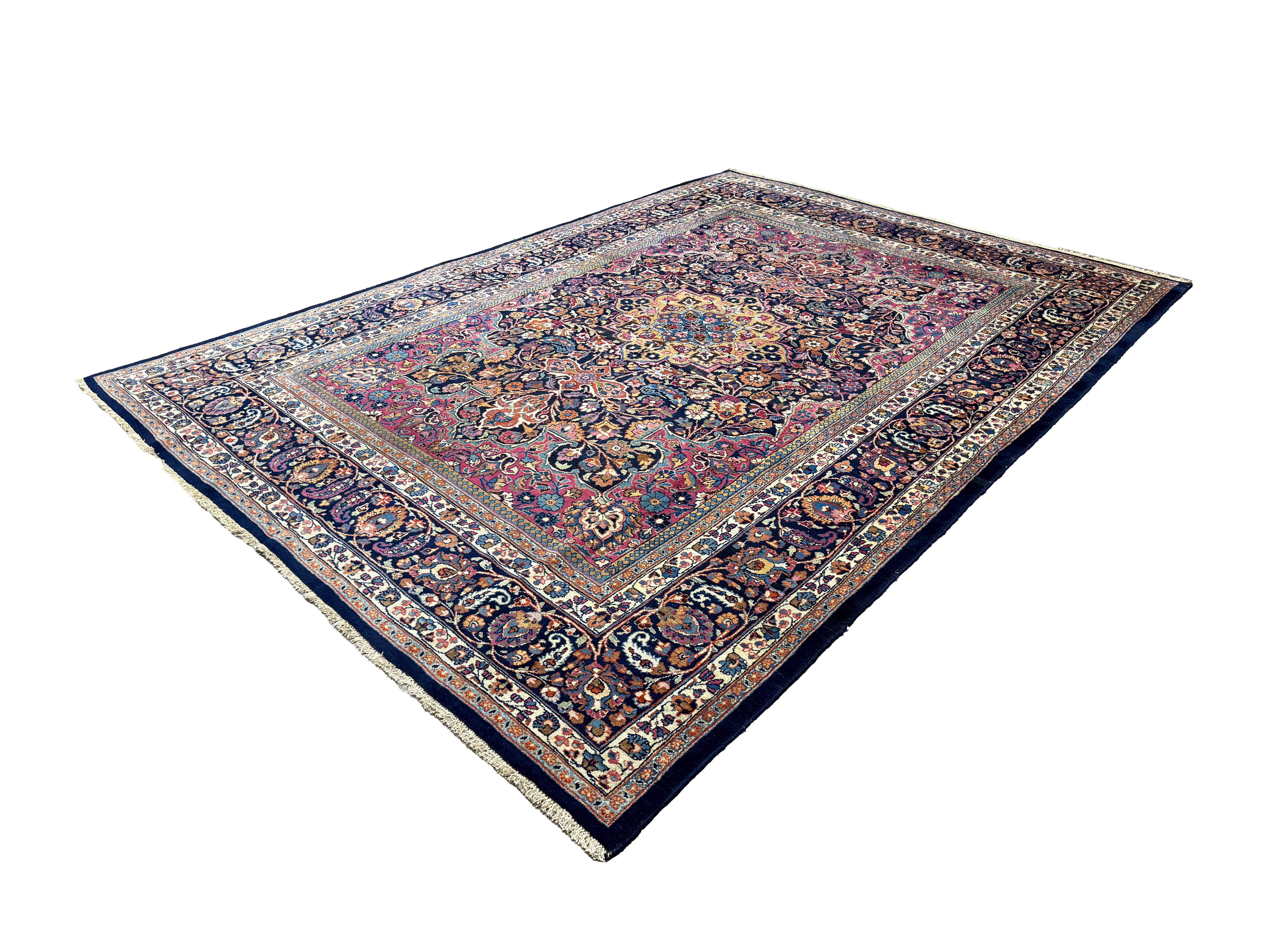 Vintage Mashhad Rug, angled view showing the full field and borders, hand-knotted wool pile. SKU EE 1.0651.