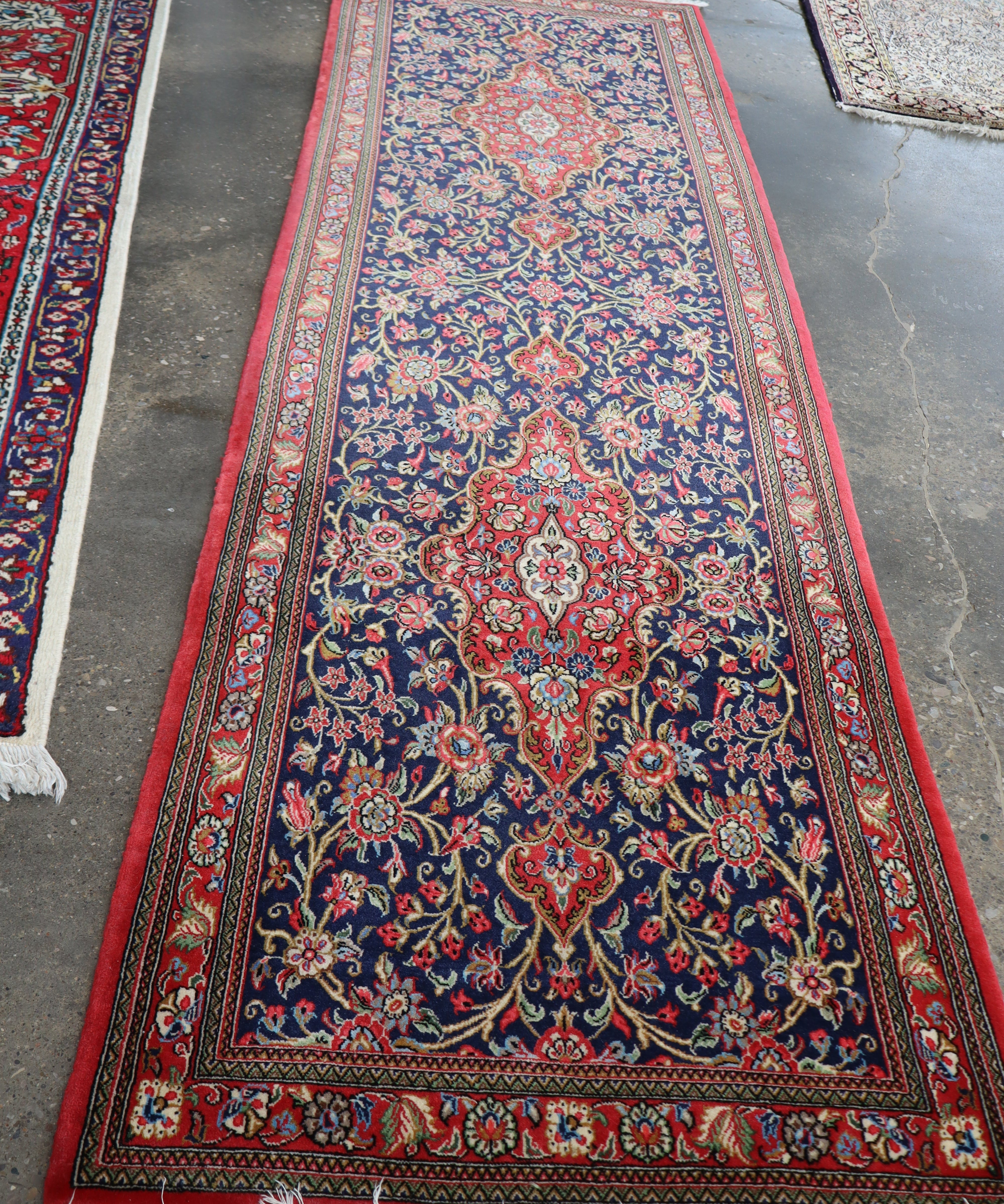 Persian Qom Kork wool runner rug, full view, red border with navy floral details