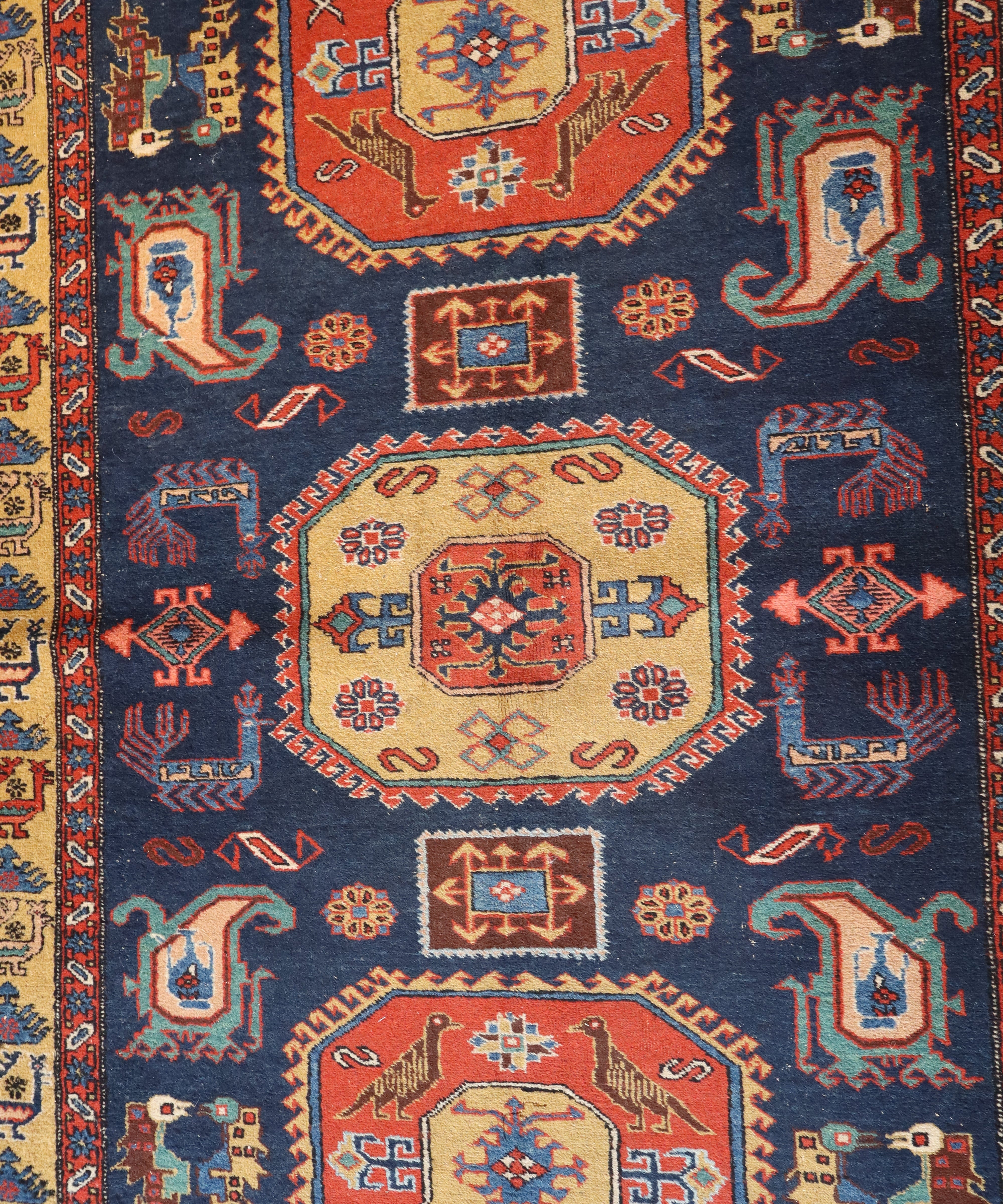 Persian mesh rug close-up of navy center with red medallion and geometric motifs