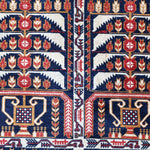 Afghan runner rug close-up of two navy-red panels with cream arches and tulip motifs.