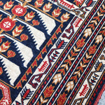 Geometric runner rug with navy, cream, and red pattern detail