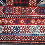 Semi-antique runner rug border detail with red, blue, cream geometric bands