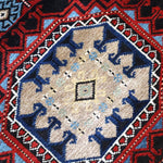 Semi-antique runner rug close detail of cream center rosette with blue accents