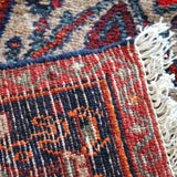 Rug edge with woven fringe and multicolor stripe band in red, blue, and cream