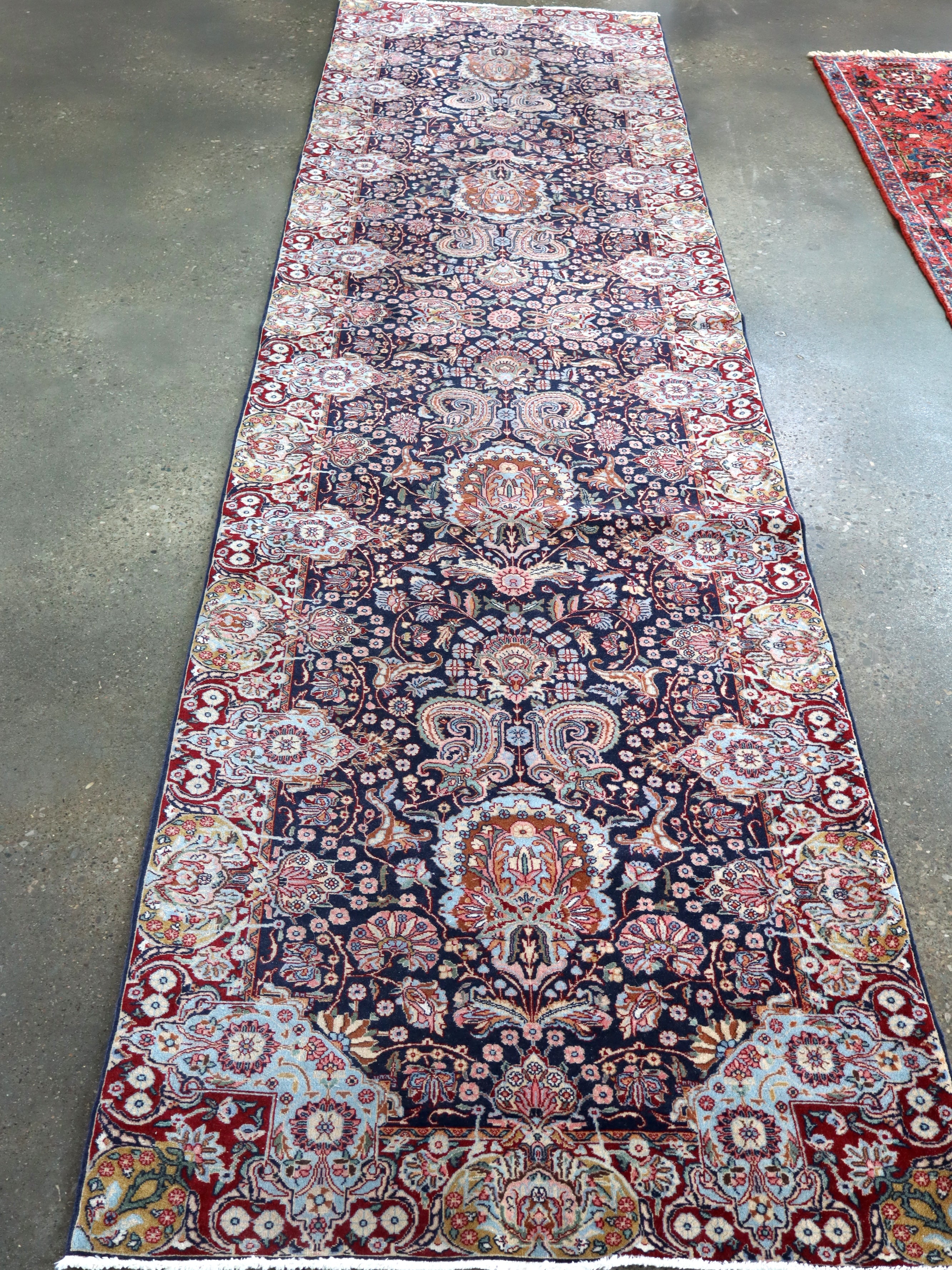 Fine Persian Kirman runner rug with navy, red, and cream medallion pattern