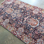 Ornate Persian-style runner rug, wide floral medallion design in navy, red, blue and cream