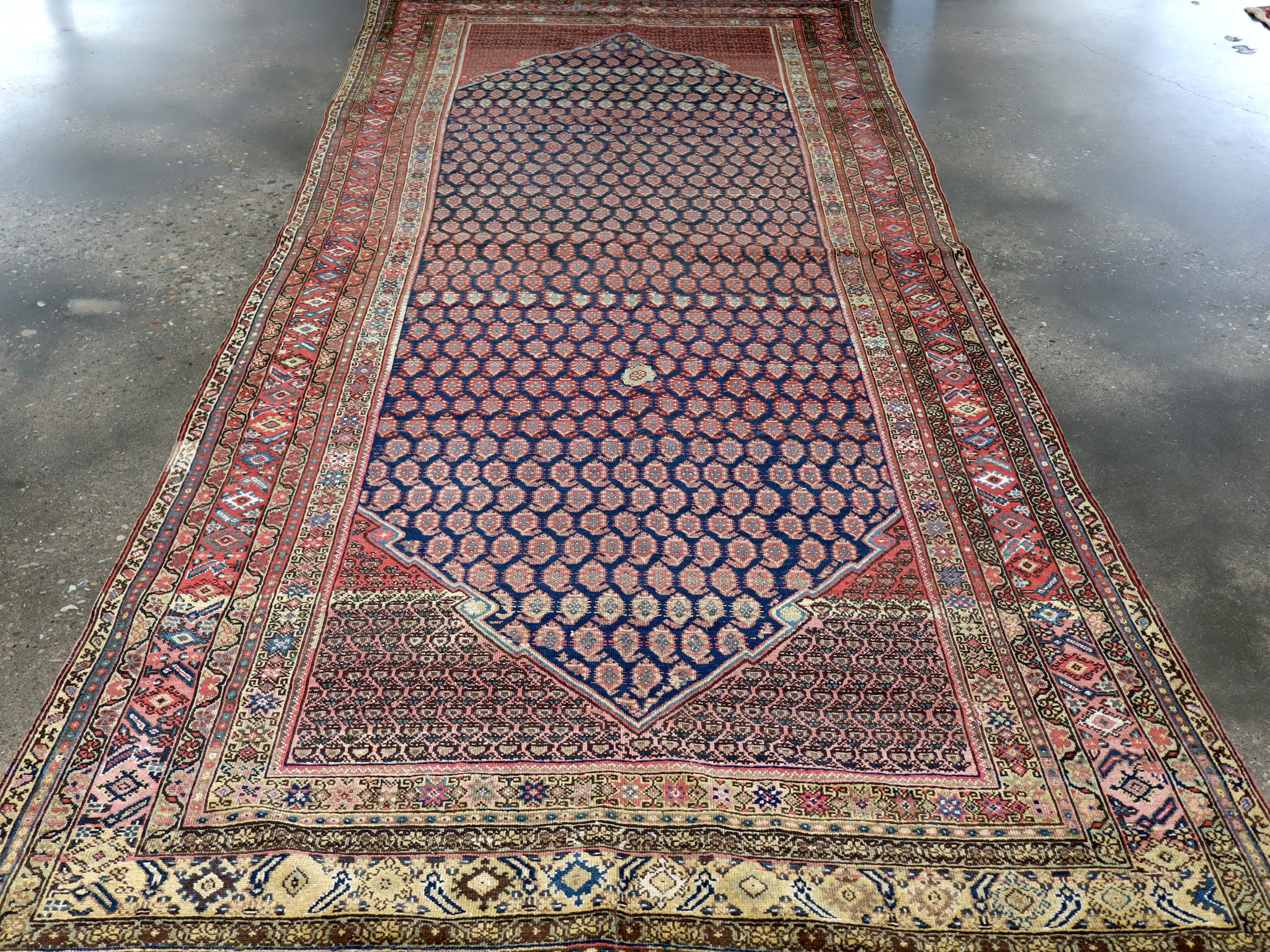Malayer Persian rug with navy allover diamond pattern and red border frame