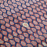 Close-up Persian Malayer rug navy geometric pattern with red and cream highlights