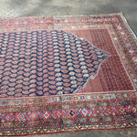 Persian Malayer rug corner detail with navy field and red border with motifs