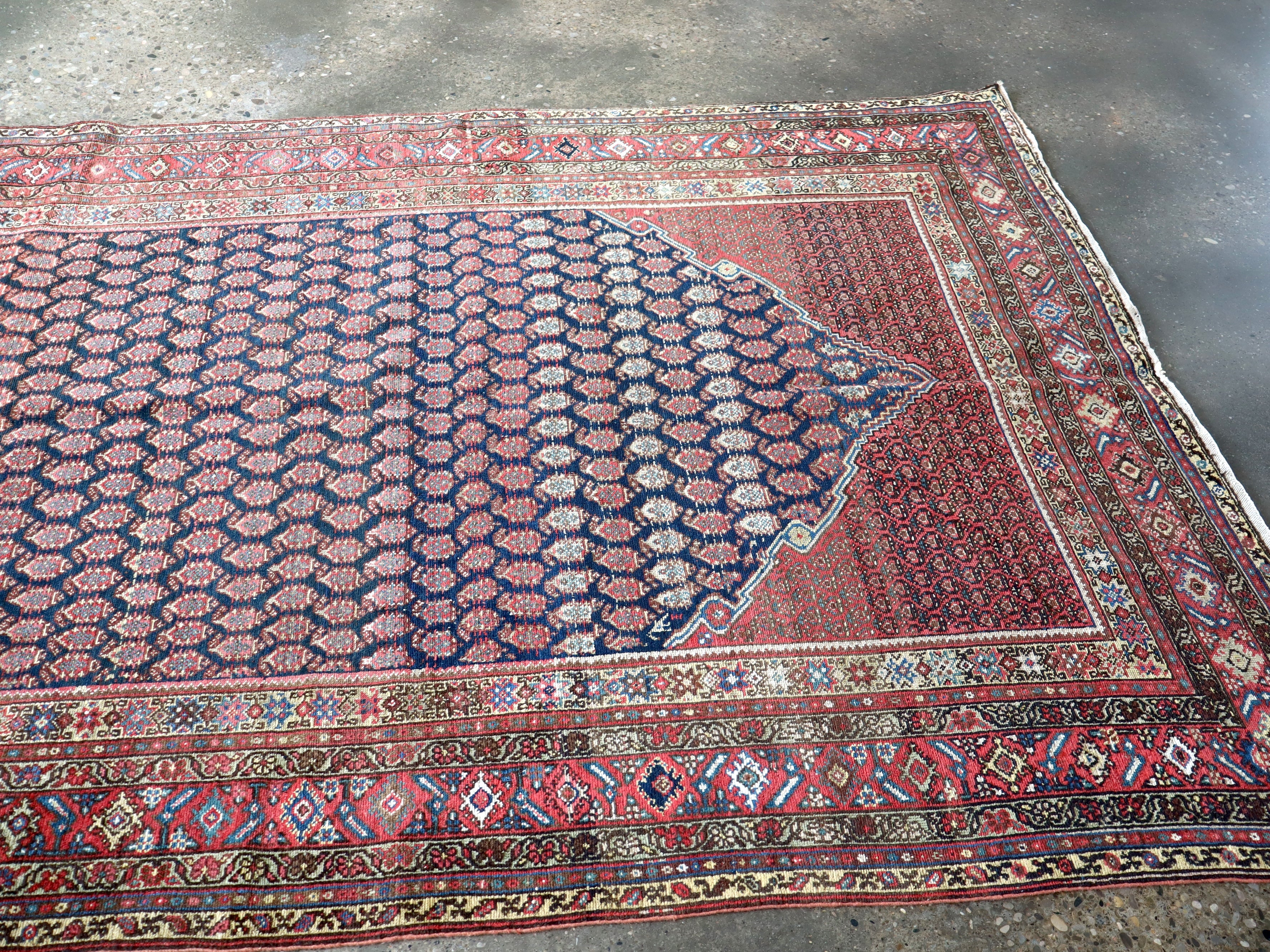 Persian Malayer rug corner detail with navy field and red border with motifs