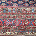 Malayer rug border with red-blue diamonds and cream decorative stripes