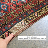 Malayer rug edge with multicolor motifs and beige fringe trim