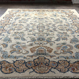 Persian Kashan rug with ivory center and blue scrollwork border; central medallion