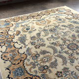 Persian Kashan rug with ivory field and blue floral swirls; decorative corner elements