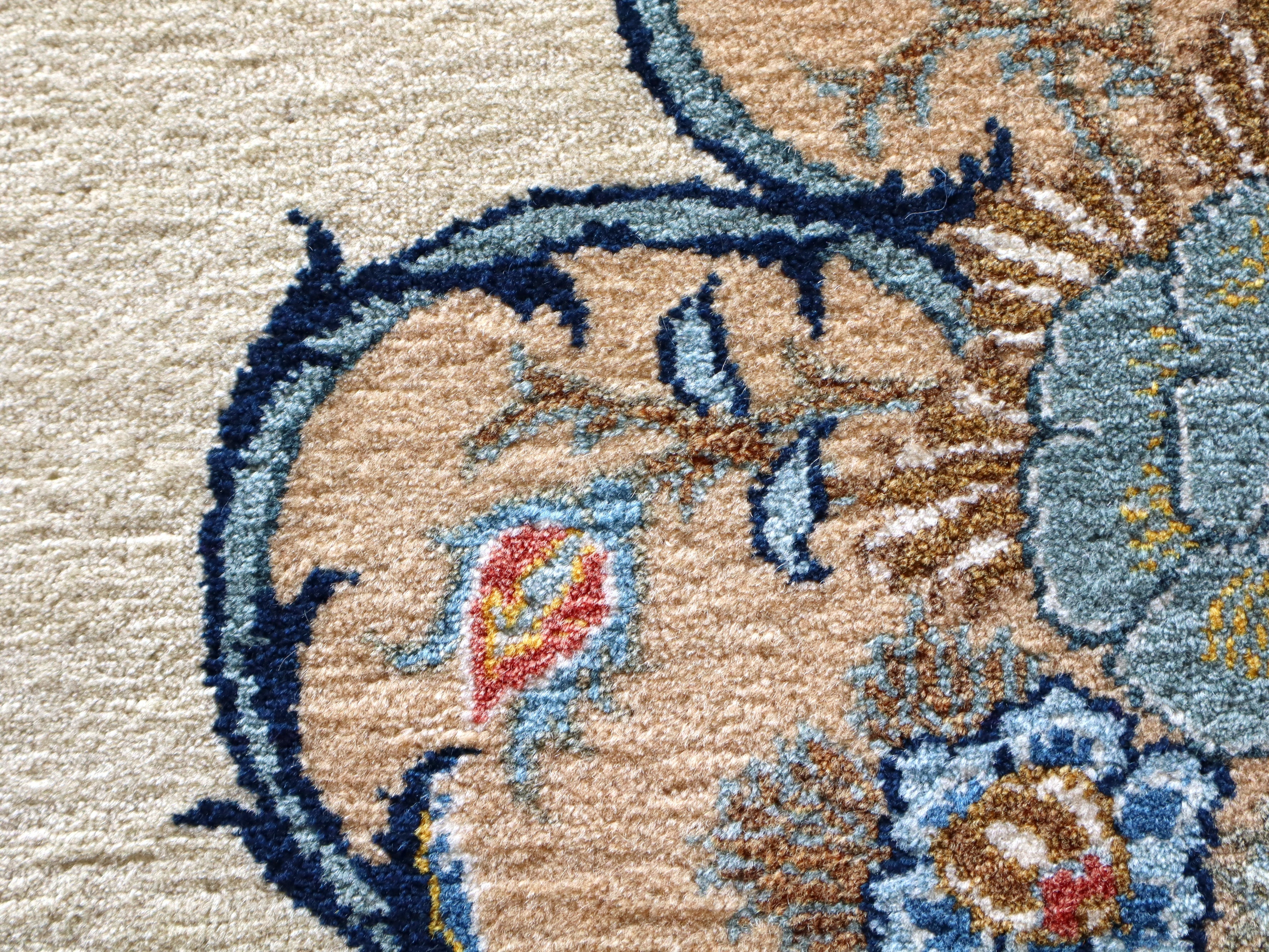Persian Kashan rug close-up corner: ivory ground with navy scroll line and small florals