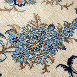 Persian Kashan rug bold center floral rosette with blue, gold, and red accents on cream