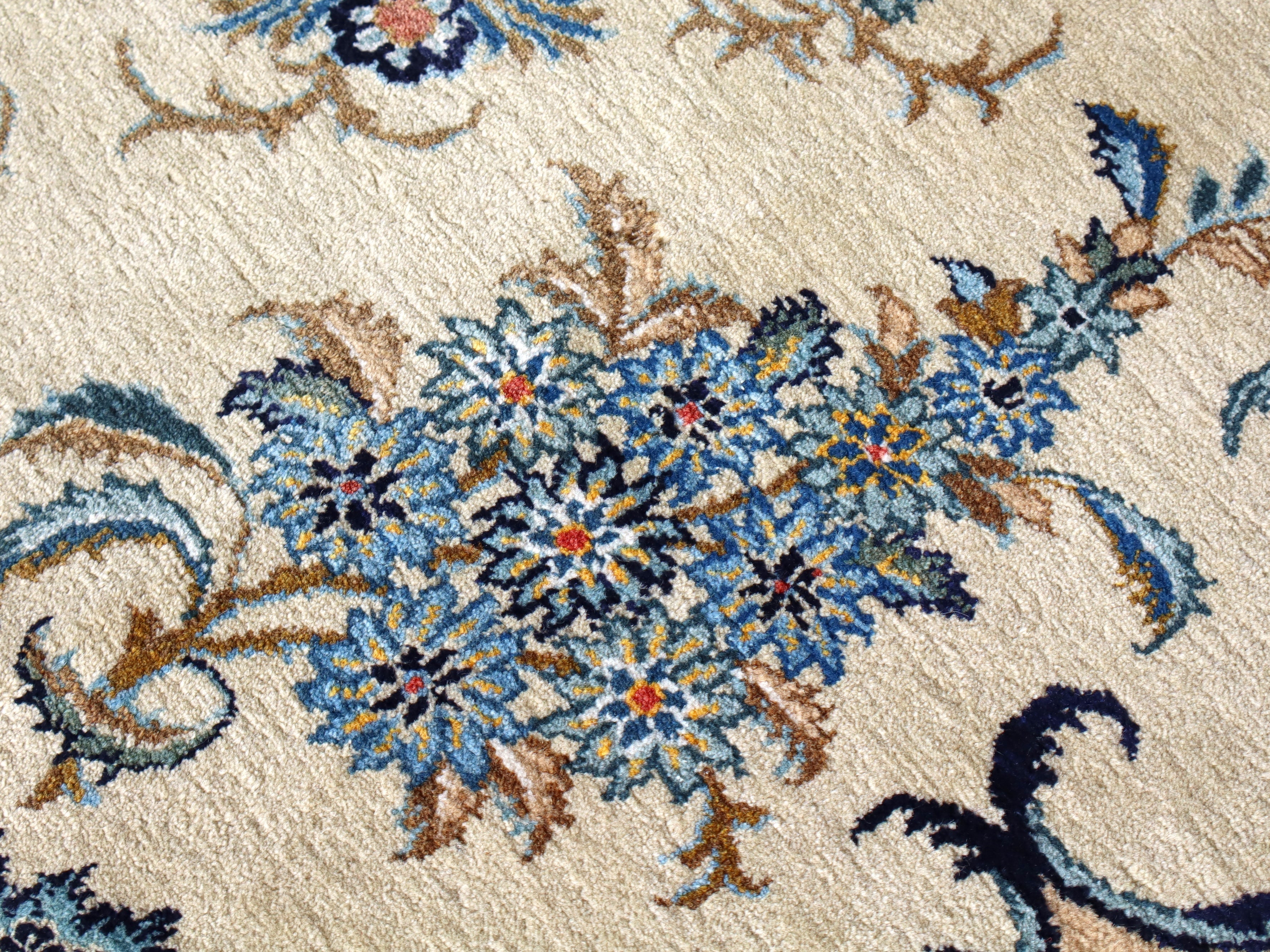 Persian Kashan rug bold center floral rosette with blue, gold, and red accents on cream
