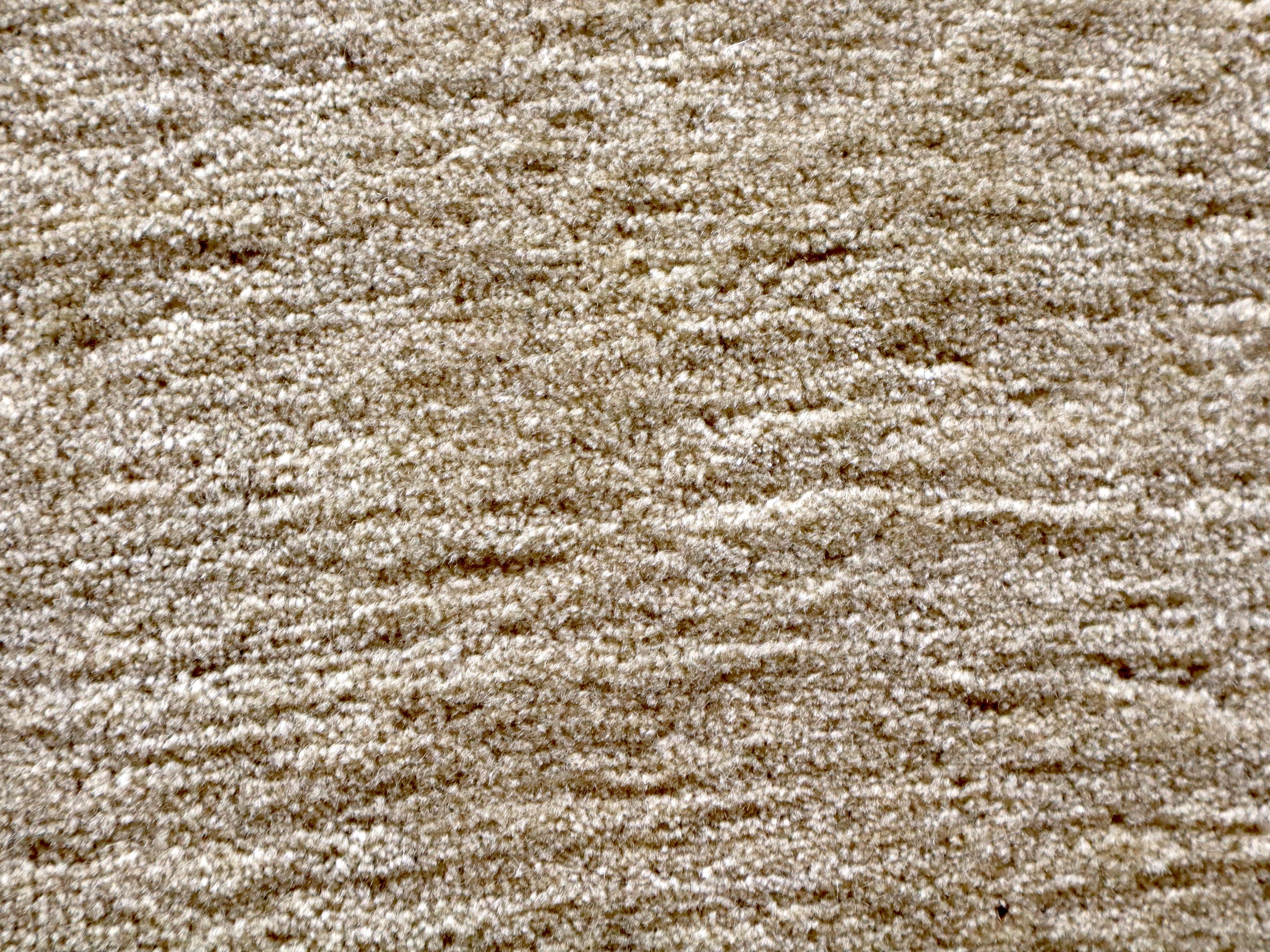 Persian Kashan rug textured cream pile surface, fine speckled weave close-up