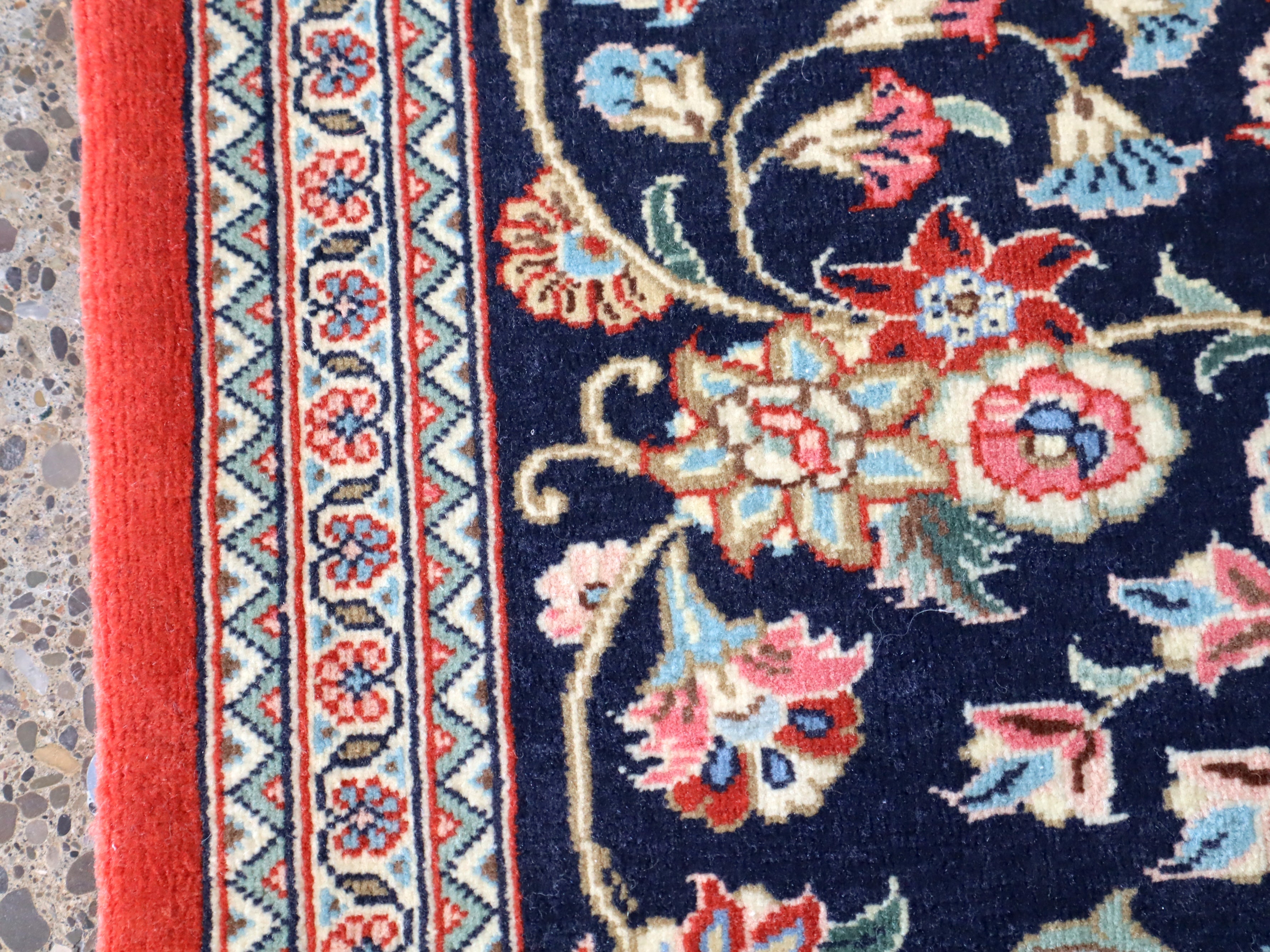 Navy Persian runner rug close-up floral vines and red accent details