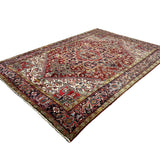 Vintage Bakhshayesh Rug, angled view showing the full field and borders, hand-knotted wool pile. SKU NH 142844.